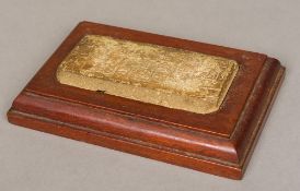 A carved stone tablet Indistinctly worked, inset into a wooden plinth base. The tablet 13.