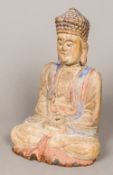 A Chinese carved wood and polychrome decorated seated Buddha, in the Tang style 33 cm high.
