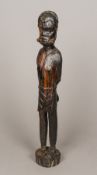 An African tribal carved wooden figure Modelled as a slave with gagged mouth,