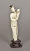 A late 19th/early 20th century Chinese carved ivory figure of a fisherman's wife Worked holding a