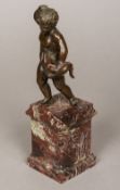 A small Renaissance patinated bronze model of a putto Modelled standing holding a snake,