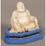 A finely carved 19th century soapstone model of Buddha Typically modelled seated,