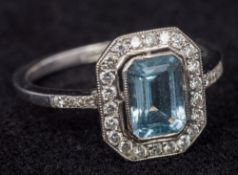 An 18 ct white gold aquamarine and diamond set Art Deco style ring The central stone emerald cut.