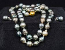 A Tahitian pearl necklace Together with a pair of paste set silver mounted pearl earrings en suite,