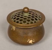 A small Chinese patinated bronze censor Of squat form, with pierced removable lid,