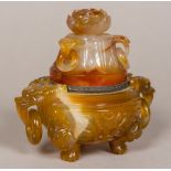 A 19th century Chinese agate inkwell Of censer form, with hinged lid and twin mask and ring handles.