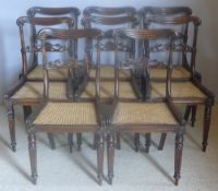 A set of eight early 19th century dining chairs Each gadrooned top rail above the scroll carved