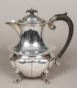 An Edwardian silver hot water jug, hallmarked Birmingham 1902,