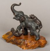 A Japanese Meiji period patinated bronze animalier group Formed as two tigers attacking an elephant,