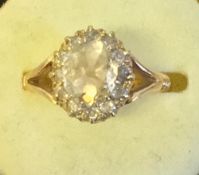An Edwardian/Victorian unmarked gold and diamond set ring The central facet cut stone spreading to