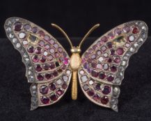An unmarked gold, ruby and diamond brooch Formed as a butterfly. 6.75 cm wide.
