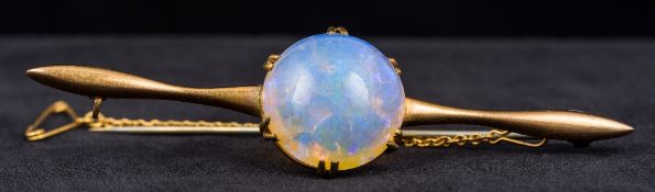An unmarked gold and opal bar brooch Centrally set with a large cabochon opal. 8 cm wide.