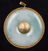 A Chinese 14K gold mounted jade pendant Of circular form,