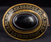 A Victorian unmarked banded agate mourning brooch The central cabochon stone above a black