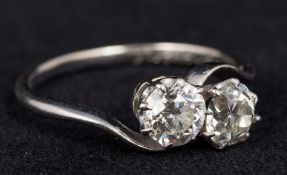 An unmarked white gold or platinum two stone diamond crossover ring Each stone approximately 0.