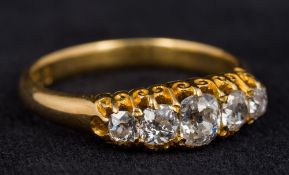 An 18 ct gold diamond five stone ring The stones claw set above pierced shoulders.