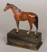 A cold painted bronze horse Naturalistically modelled, standing on a plinth base.