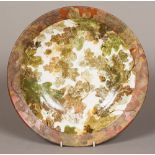 RALPH JANDRELL (20th/21st century) British A Studio pottery dished platter Decorated in the Oak