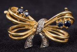 A 9 ct gold diamond and sapphire set bow brooch 2.5 cm wide.