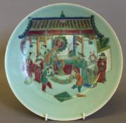 A Chinese porcelain plate Polychrome decorated with courtly figures on a celadon ground,