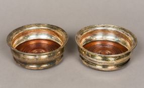 A pair of matched silver bottle coasters, hallmarked London 1964 and 1965,