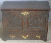 A small 18th century oak coffer The hinged moulded rectangular top above the dragon carved panelled