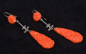 A pair of Art Deco carved coral earrings Of drop form with floral decorations. 6 cm high.