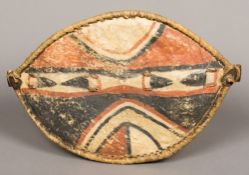 A Maasai animal hide shield Of typical form and polychrome decorated. 49 cm high.