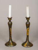 A pair of 19th century Persian lacquered wooden candlesticks Each decorated in the round with