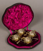 A set of four Victorian silver and silver gilt twin handled salts and spoons,