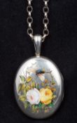 An unmarked silver and enamel locket Of hinged oval form,