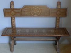 A 19th century North African bone inlaid hardwood settle The shaped back above the panelled moulded