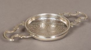 A George III silver two handled lemon strainer,