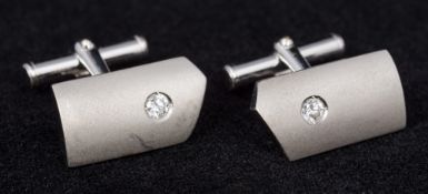 A pair of 18 ct white gold and diamond cufflinks Each of T-bar form, set with a single stone.