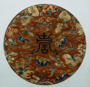 A Chinese embroidered silk roundel Centred with Shau character, framed and glazed.