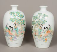 A pair of Chinese porcelain vases Decorated with female figures and children on a terrace opposing