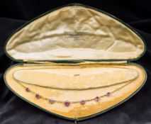 A late Victorian/Edwardian unmarked gold amethyst and seed pearl necklace Set with seven graduated