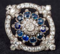 A Victorian diamond and sapphire set white and yellow gold brooch The central stone 0.