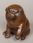 A Japanese patinated bronze model of a dog, possibly an Akita puppy Modelled seated. 13 cm high.