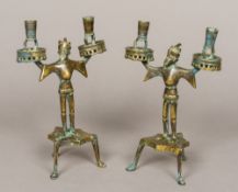 A pair of late 15th century style cast brass Mannlein-Leuchter candlesticks Each with a pair of