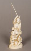 A 19th century Japanese carved ivory okimono Worked as a fisherman and his young companion catching