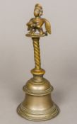 An antique Indian cast bronze hand bell With fertility figure finial. 27.5 cm high.