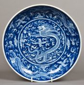 A Chinese blue and white porcelain dish Worked with dragons chasing flaming pearls interspersed