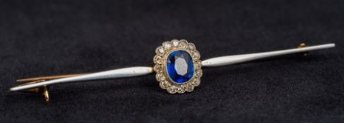 An unmarked gold sapphire and diamond bar brooch Of central flowerhead form, housed in a fitted box.
