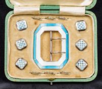 A cased set of Edwardian enamel decorated silver buckle and shirt studs,