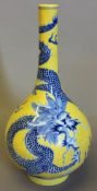 A Chinese porcelain vase Decorated with a dragon and leaping carp above stylised waves on a yellow