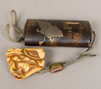 A Japanese lacquered inro The outer sheath decorated with butterflies and a bow tied cabinet,