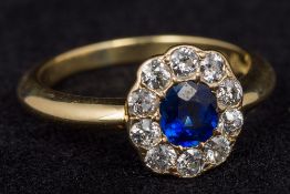 An 18 ct gold sapphire and diamond set cluster ring Size O, cased.