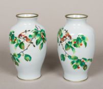 A pair of fine quality cloisonne vases Each decorated with two small birds on a fruiting branch