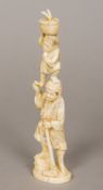 A 19th century Japanese carved ivory okimono Of a woodsman balancing his son on his head.